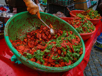 A boy sells various kinds of pickles at a market on a cold winter day in Srinagar, Jammu and Kashmir, on December 01, 2024. (