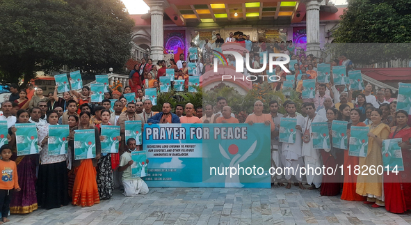 Members of the International Society for Krishna Consciousness (ISKCON) and devotees hold placards at ISKCON Temple in Siliguri, India, on D...