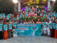 Members of the International Society for Krishna Consciousness (ISKCON) and devotees hold placards at ISKCON Temple in Siliguri, India, on D...