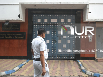 A Kolkata police officer passes next to the Bangladesh High Commissioner's office in Kolkata, India, on December 1, 2024. Security is impose...