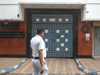 A Kolkata police officer passes next to the Bangladesh High Commissioner's office in Kolkata, India, on December 1, 2024. Security is impose...