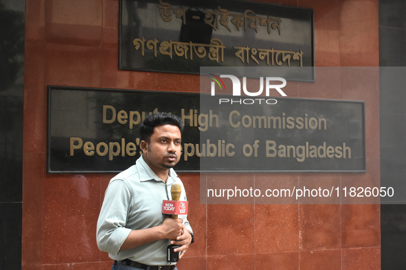 A media person stands in front of the Bangladesh High Commissioner's office during a broadcast in Kolkata, India, on December 1, 2024. Secur...