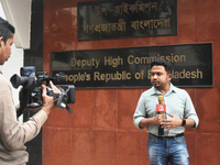 A media person stands in front of the Bangladesh High Commissioner's office during a broadcast in Kolkata, India, on December 1, 2024. Secur...