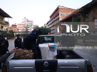 Nepal Police personnel load a ballot box into the vehicle to transport it to a vote-counting center after the completion of voting in Nepal'...