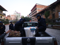 Nepal Police personnel load a ballot box into the vehicle to transport it to a vote-counting center after the completion of voting in Nepal'...