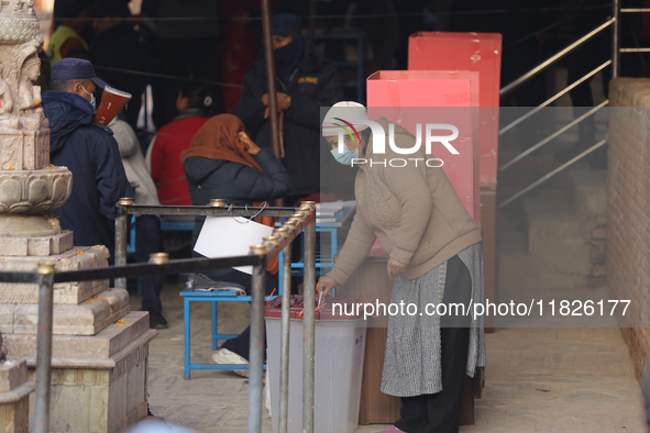 A Nepali voter casts a vote in the local by-election at a polling center in Kathmandu, Nepal, on December 1, 2024. A periodic election to el...