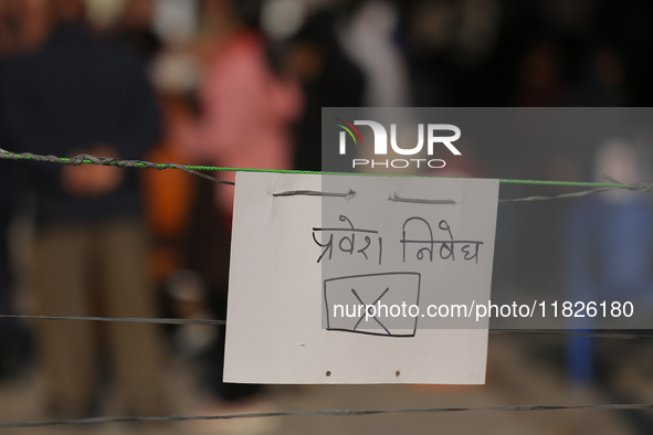 A sign reading ''No entry'' in Nepali script hangs at a polling station in Kathmandu, Nepal, on December 1, 2024. A periodic election to ele...