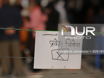 A sign reading ''No entry'' in Nepali script hangs at a polling station in Kathmandu, Nepal, on December 1, 2024. A periodic election to ele...