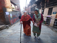 An elderly voter walks towards a nearby polling center to exercise her franchise in the local level by-election held in Kathmandu, Nepal, on...