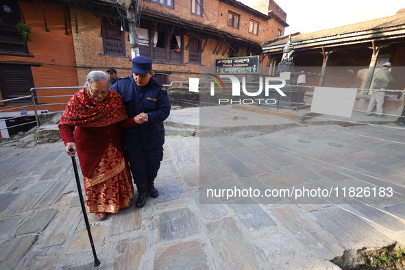 An elderly voter walks towards a nearby polling center to exercise her franchise in the local level by-election held in Kathmandu, Nepal, on...