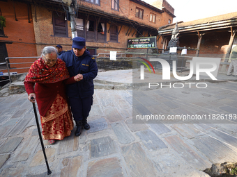 An elderly voter walks towards a nearby polling center to exercise her franchise in the local level by-election held in Kathmandu, Nepal, on...