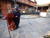 An elderly voter walks towards a nearby polling center to exercise her franchise in the local level by-election held in Kathmandu, Nepal, on...