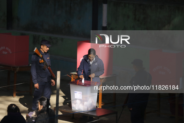 A Nepali voter casts a vote in the local by-election at a polling center in Kathmandu, Nepal, on December 1, 2024. A periodic election to el...