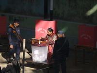 A Nepali voter casts a vote in the local by-election at a polling center in Kathmandu, Nepal, on December 1, 2024. A periodic election to el...