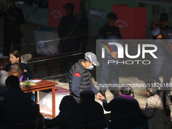 A Nepali voter casts a vote in the local by-election at a polling center in Kathmandu, Nepal, on December 1, 2024. A periodic election to el...