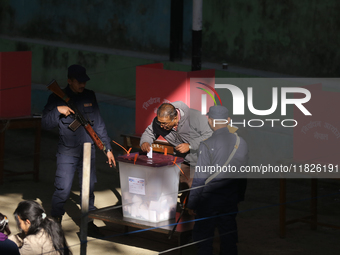 A Nepali voter casts a vote in the local by-election at a polling center in Kathmandu, Nepal, on December 1, 2024. A periodic election to el...