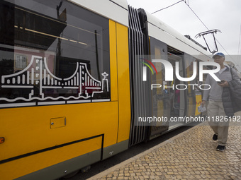 A person walks in Lisbon, Portugal, on December 1, 2024. The capital of Portugal is one of Europe's oldest and most vibrant cities. It is kn...