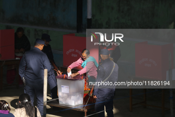 A Nepali voter casts a vote in the local by-election at a polling center in Kathmandu, Nepal, on December 1, 2024. A periodic election to el...