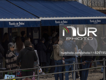 People wait in line to enter a pastry shop in Lisbon, Portugal, on December 1, 2024. Lisbon, the capital of Portugal, is one of Europe's old...