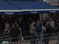 People wait in line to enter a pastry shop in Lisbon, Portugal, on December 1, 2024. Lisbon, the capital of Portugal, is one of Europe's old...