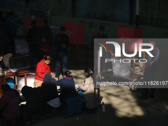 A Nepali voter casts a vote in the local by-election at a polling center in Kathmandu, Nepal, on December 1, 2024. A periodic election to el...