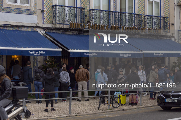 People wait in line to enter a pastry shop in Lisbon, Portugal, on December 1, 2024. Lisbon, the capital of Portugal, is one of Europe's old...