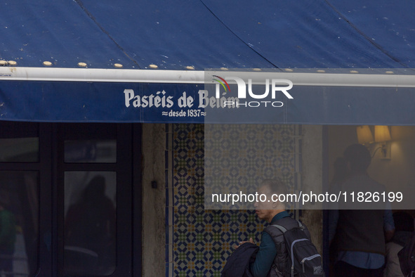 In Lisbon, Portugal, on December 1, 2024, a person waits in line to enter a pastry shop. Lisbon, the capital of Portugal, is one of Europe's...