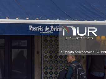 In Lisbon, Portugal, on December 1, 2024, a person waits in line to enter a pastry shop. Lisbon, the capital of Portugal, is one of Europe's...