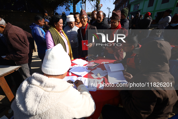 Candidates contesting the election and voters search for their registration numbers before heading to the polls in Nepal's local by-election...