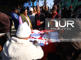 Candidates contesting the election and voters search for their registration numbers before heading to the polls in Nepal's local by-election...