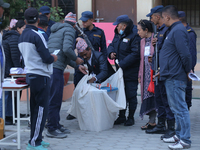 Election officials pack a ballot box to dispatch it to a counting center after the completion of voting in a local by-election held in Kathm...