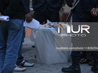 A sealed ballot box is guarded by election officials and security personnel at a local polling station after the completion of voting in loc...