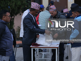 Election officials pack other essentials to dispatch them to a counting center after the completion of voting in a local by-election in Kath...