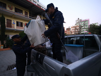 Nepal Police personnel load a ballot box into the vehicle to transport it to a vote-counting center after the completion of voting in Nepal'...