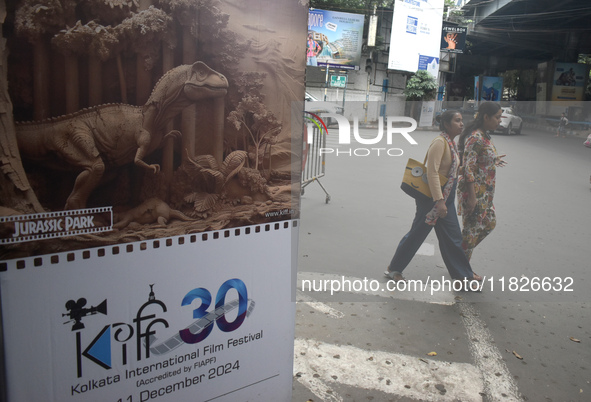 Women pass next to a poster of the International Film Festival in Kolkata, India, on December 1, 2024. The International Film Festival start...