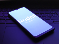 The Redmi by Xiaomi logo appears on the screen of a smartphone in Reno, United States, on December 1, 2024. (