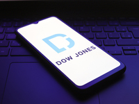 The Dow Jones Industrial Average logo appears on the screen of a smartphone in Reno, United States, on December 1, 2024. (