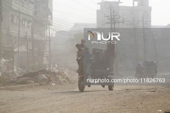 Residents make their way amid unhealthy air quality in Dhaka, Bangladesh, on December 1, 2024. 