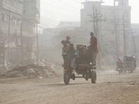 Residents make their way amid unhealthy air quality in Dhaka, Bangladesh, on December 1, 2024. (