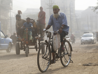 Residents make their way amid unhealthy air quality in Dhaka, Bangladesh, on December 1, 2024. (