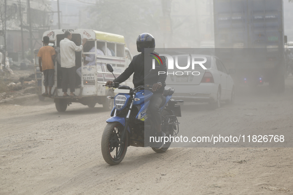 Residents make their way amid unhealthy air quality in Dhaka, Bangladesh, on December 1, 2024. 