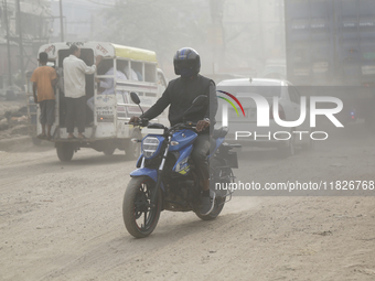 Residents make their way amid unhealthy air quality in Dhaka, Bangladesh, on December 1, 2024. (