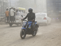 Residents make their way amid unhealthy air quality in Dhaka, Bangladesh, on December 1, 2024. (