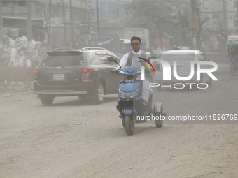 Residents make their way amid unhealthy air quality in Dhaka, Bangladesh, on December 1, 2024. (