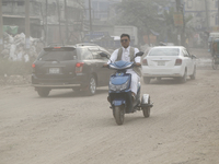 Residents make their way amid unhealthy air quality in Dhaka, Bangladesh, on December 1, 2024. (