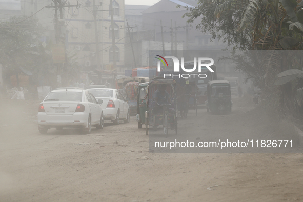 Commuters make their way amid unhealthy air quality in Dhaka, Bangladesh, on December 1, 2024. 