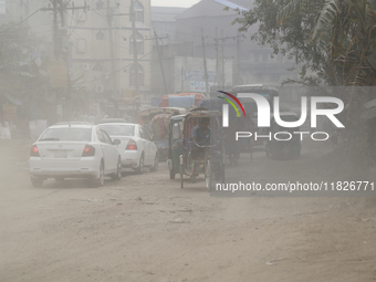 Commuters make their way amid unhealthy air quality in Dhaka, Bangladesh, on December 1, 2024. (