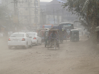 Commuters make their way amid unhealthy air quality in Dhaka, Bangladesh, on December 1, 2024. (