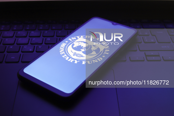 The International Monetary Fund (IMF) logo appears on the screen of a smartphone in Reno, United States, on December 1, 2024. 