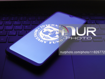 The International Monetary Fund (IMF) logo appears on the screen of a smartphone in Reno, United States, on December 1, 2024. (